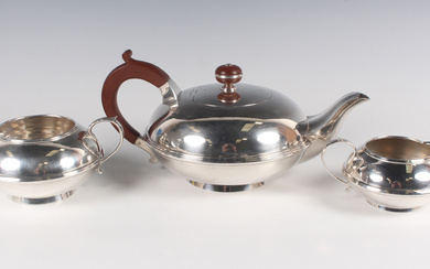An Art Deco silver three-piece tea set, comprising teapot, milk jug and sugar bowl, each of girdled