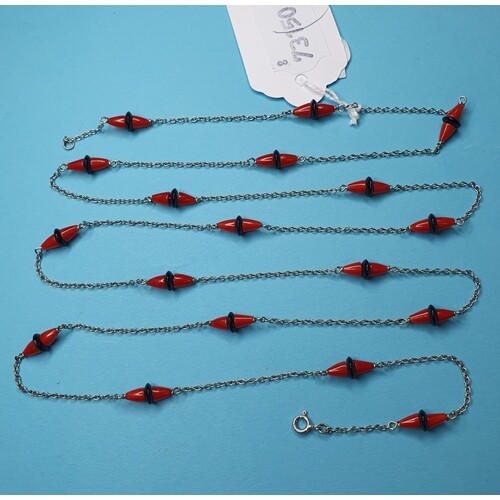 An Art Deco white gold, onyx and coral long chain