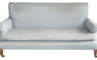 An Edwardian upholstered sofa in the manner of Howard and Sons
