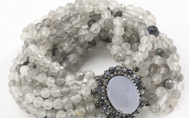 An agate and sapphire bracelet with numerous gray agate pearls and clasp set with oval-cut chalcedony encircled by faceted iolites, mounted in oxidized silver.