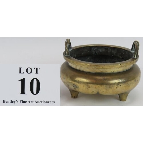 An antique Chinese bronze censer raised on trilobed three fe...