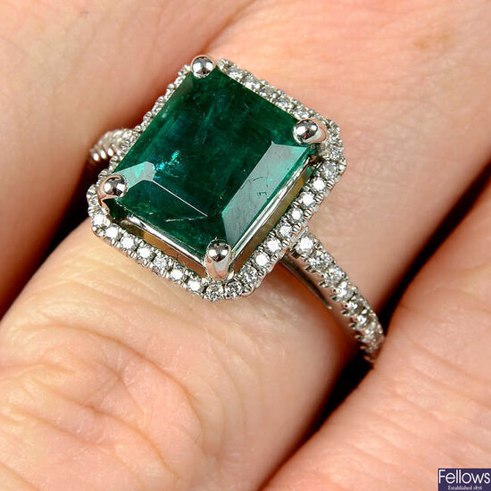An emerald and brilliant-cut diamond ring.