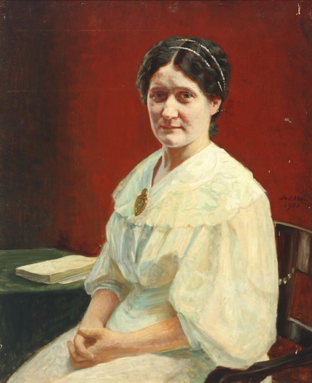 Axel Hou: Interior with a woman sitting by a red wall. Signed and dated Axel Hou, 1908. Oil on canvas. 83×69 cm.