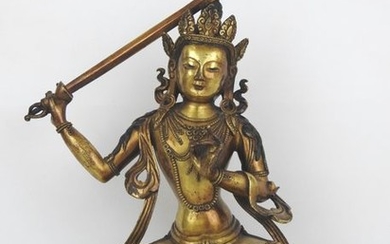CHINA: Statue in gilt bronze representing Manjushri Acala,...