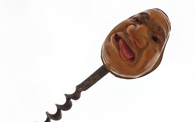 Coquilla nut corkscrew carved with a face, 11cm in length