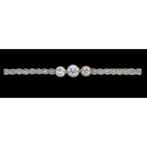 DIAMOND BAR BROOCH, set with 3 larger diamonds to the center...