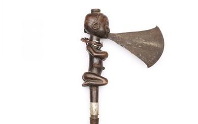 D.R. Congo, Luba, axe, the blade issues from the squatting female's mouth.
