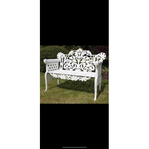 Decorative cast iron garden bench with arms terminating in R...