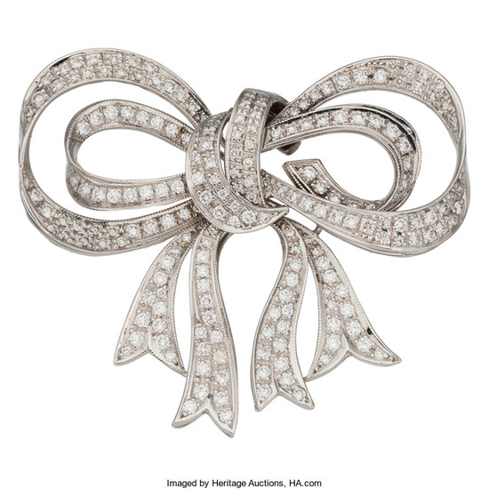 Diamond, White Gold Brooch The bow brooch features full-cut...