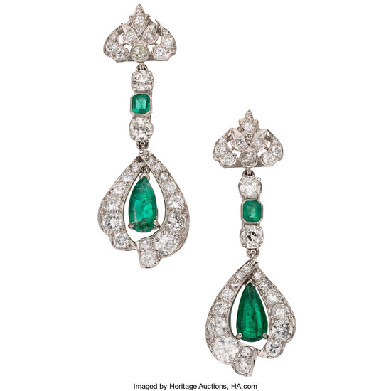 Emerald, Diamond, Platinum Earrings The earrings feature pear-shaped and...