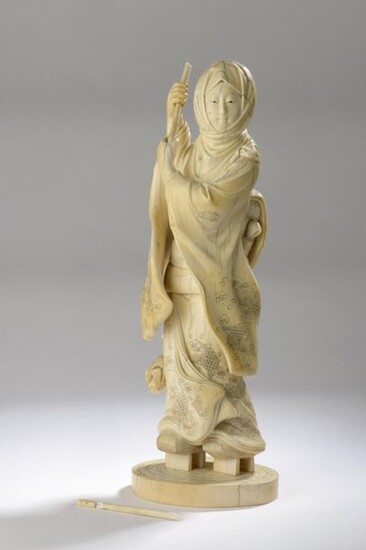 Ivory okimono carved and enhanced with ink, woman...