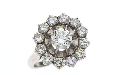 Lot 110 BAGUE "Fleur" en or 750/°° et platine 850/°° ornée d'un diamant taillé en brillant de...