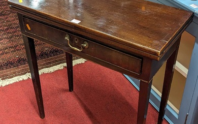 Lot details A George III mahogany fold-over tea table, with...