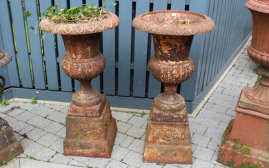 Lot details A pair of cast iron pedestal garden urns,...