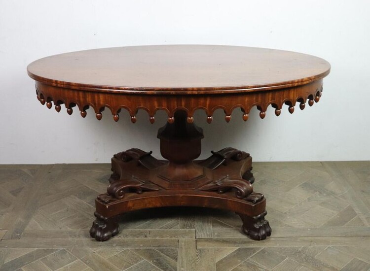Middle table in mahogany and mahogany veneer, the belt fretworked and punctuated with olives.