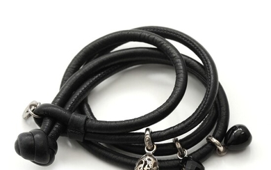SOLD. Ole Lynggaard: A black leather "Sweet Drop" bracelet with two sterling silver charms and...