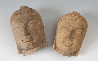 Pair of Buddhas' heads; India, 19th century. Stone. They have wear.