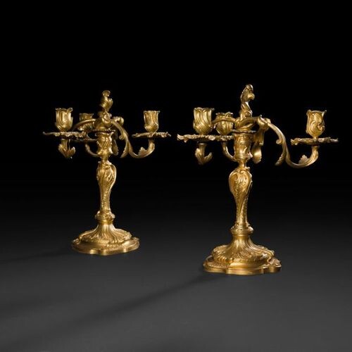 Pair of three-light gilt bronze candelabra, the shaft with an...