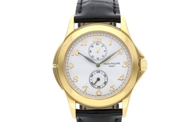 Patek Philippe Reference 5134J-001 Travel Time | Retailed by Tiffany & Co.: A yellow gold dual time wristwatch with 24-hour indication, Circa 2005