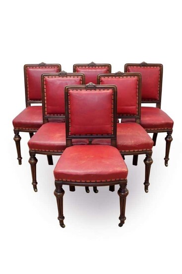 Set of six Victorian walnut and close stud upholstered dining chairs, each with moulded framed and square pad back and seat on knopped fluted legs and castors
