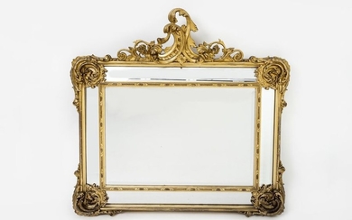 Spectacular mirror. Landscape format, carved and stuccoed, gilded....