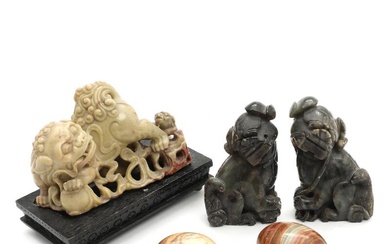 Three Chinese jade guardian lions, comprising a pair and a single with...