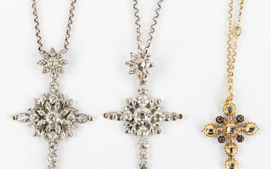 Three antique pendants in the shape of a crucifix, with old-cut diamonds. 18kt white and yelow gold.