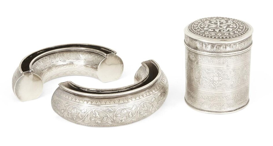 Two crescent-shaped vases, white metal, probably Malaysian, 20th century, the undersides engraved with Arabic script, unidentified marks to base, 15cm dia., together with a cylindrical white metal box engraved with floral bands, 8.5cm high (3)