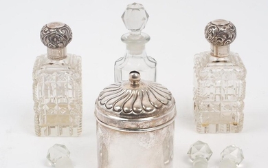 Two silver mounted glass vanity bottles, Birmingham, 1897, C. May & Sons, the rectangular cut glass bottles to screw caps, 11.8cm high, together with a cylindrical vanity box with fluted lid, base stamped sterling 925, 10.7cm high; three cut glass...
