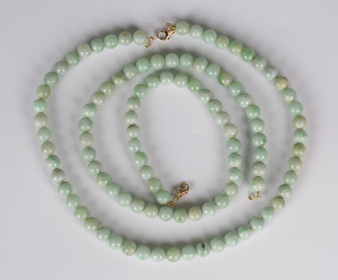Two single row necklaces of spherical jade beads, each with a gold sprung hook shaped clasp, lengths