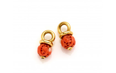 Two yellow gold pendants with carved variegated orange coral, in all g 7.56 circa, length cm 2.50 circa. Marked 179...