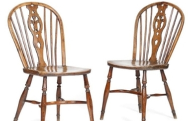 A pair of early 19th century yew side chairs in th…