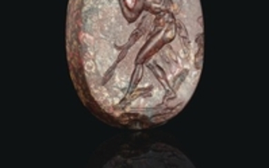 A GREEK MOTTLED RED JASPER SCARABOID WITH PERSEUS, CLASSICAL PERIOD, CIRCA 4TH CENTURY B.C.