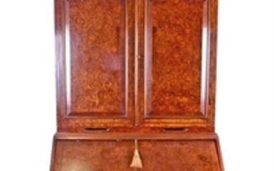 A Queen Anne style burr walnut bureau bookcase with double dome top and arched doors enclosing three shelves, above a cross...