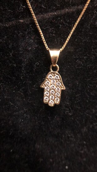14KT Yellow Gold Pendant Necklace Hamsa inlaid with a 1.9 gram spotlight