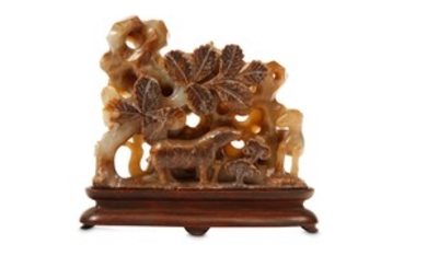 A CHINESE RUSSET JADE ‘RAMS’ CARVING. Qing Dynasty....