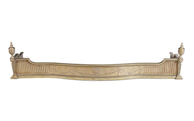 A SERPENTINE BRASS FENDER, with punched and fluted...