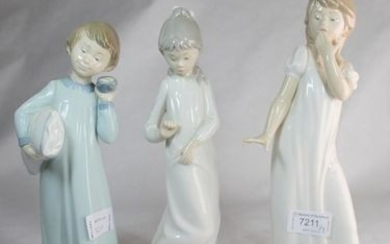 Three Nao figurines of children dressed in night clothes, the tallest 29cm.