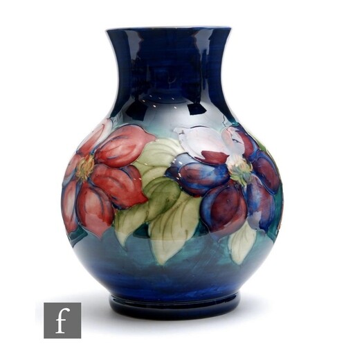 A 1950s Moorcroft vase of globe and shaft form decorated in ...