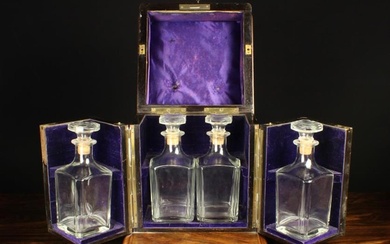 A 19th Century Burr Walnut Four Bottle Decanter Box having a hinged lid and two swing out compartmen