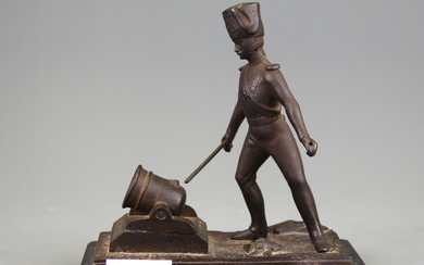 A 19th Century cast bronze match striker on a black slate base, H. 18cm.
