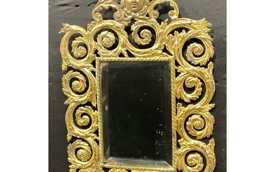 A 19th century gilt metal looking glass, cast in the Baroque...