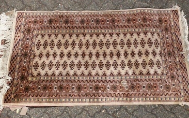 A 20TH CENTURY BOKHARA STYLE RUG, beige ground with