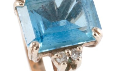 A 9CT GOLD TOPAZ AND DIAMOND RING; set with an emerald cut blue topaz of approx. 3.00ct (chipped), between shoulders set with 4 roun...
