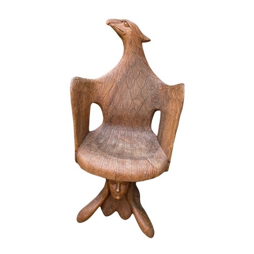 A CARVED WOODEN ARMCHAIR, in the form of an eagle supported ...