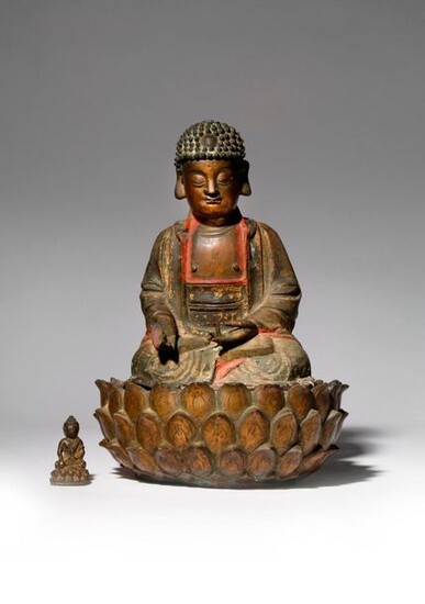 A CHINESE PARCEL-GILT AND LACQUERED-BRONZE FIGURE OF BUDDHA MING DYNASTY...