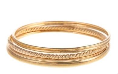 A Collection of Four Bangles in 14K Yellow Gold