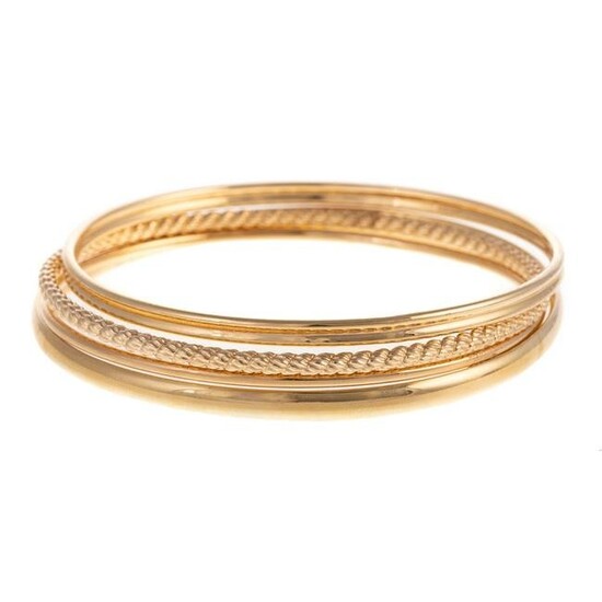 A Collection of Four Bangles in 14K Yellow Gold