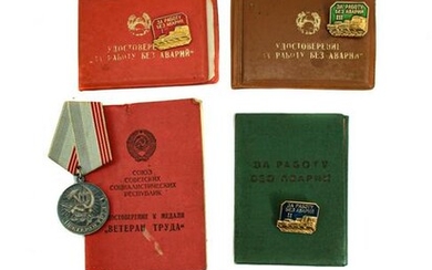A DOCUMENTED GROUP RUSSIAN SOVIET MEDAL AND BADGES