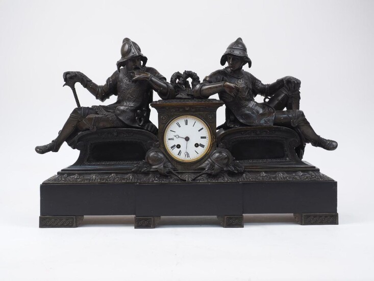 A French bronze mantel clock, late 19th century, the white enamel dial flanked by two reclining soldiers on scroll seats, on a black marble base, twin-barrel eight-day movement lacking bell and pendulum, 38cm high, 59cm wide, 15cm deep Please note...